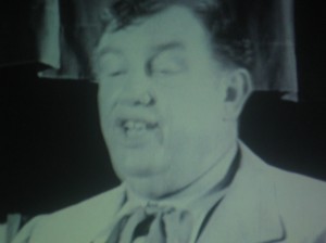 Andy Devine sings a chilling rendition of "Jesus loves me" to an audience of children...